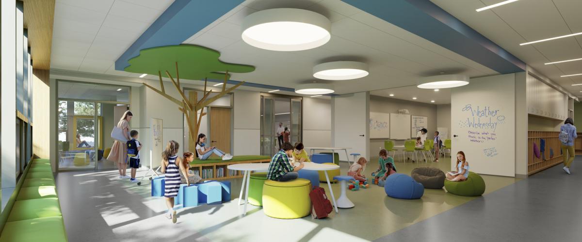 Bright, open learning area with nature‑themed decor, round tables, and children engaged in activities on soft seating.