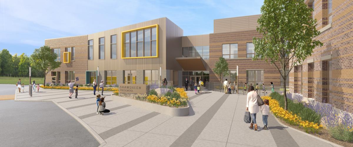 Modern preschool entrance with brick and metal accents, wide walkways, and landscaped flower beds as students and families approach the doors.