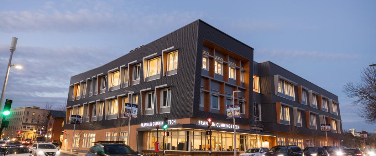 Street view of completed Franklin Cummings Tech building at night.