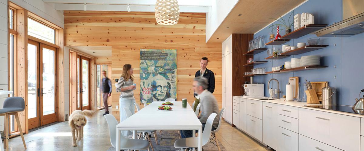 A bright, contemporary kitchen and dining area defined by clean lines, natural wood accents, and ample natural light.