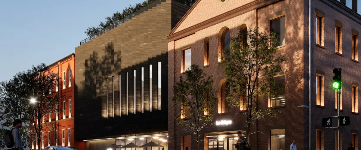 Ground level rendering showing a new portion of the building meeting the street and the adaption of an existing building into the base of the building.