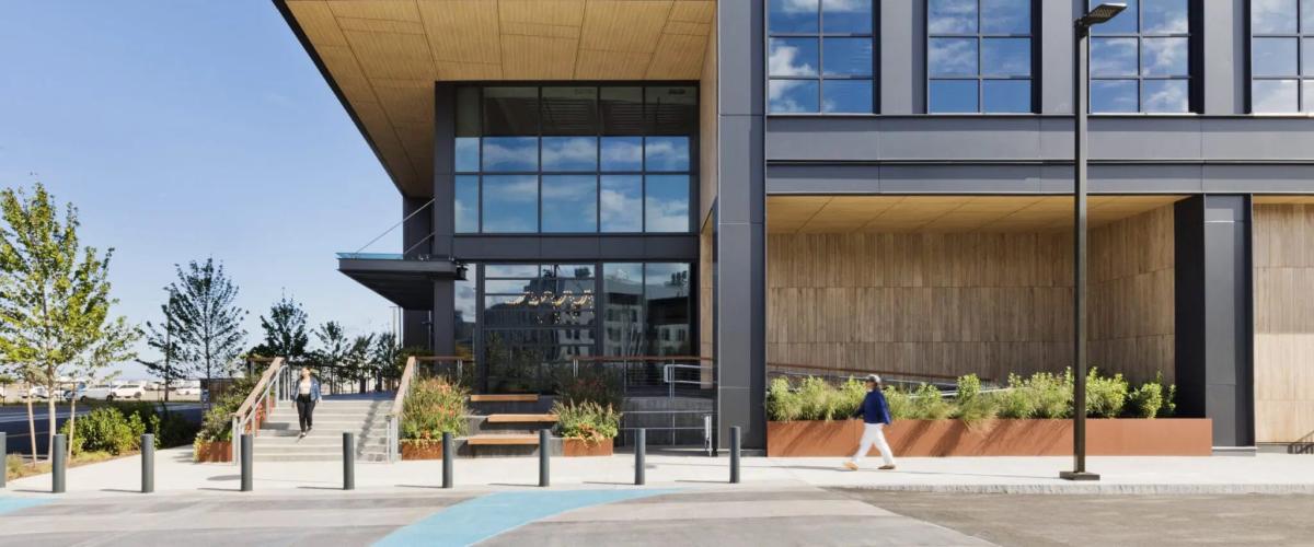 Exterior view of the building entry, designed like a carved out corner of a cube