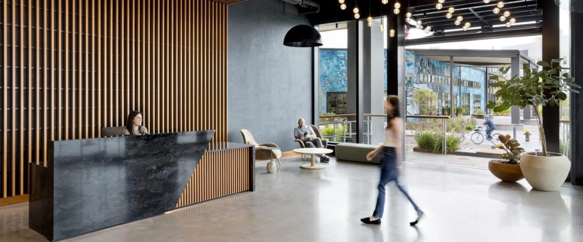Interior lobby view showing the visual connection to the adaptive reuse amenity building on site