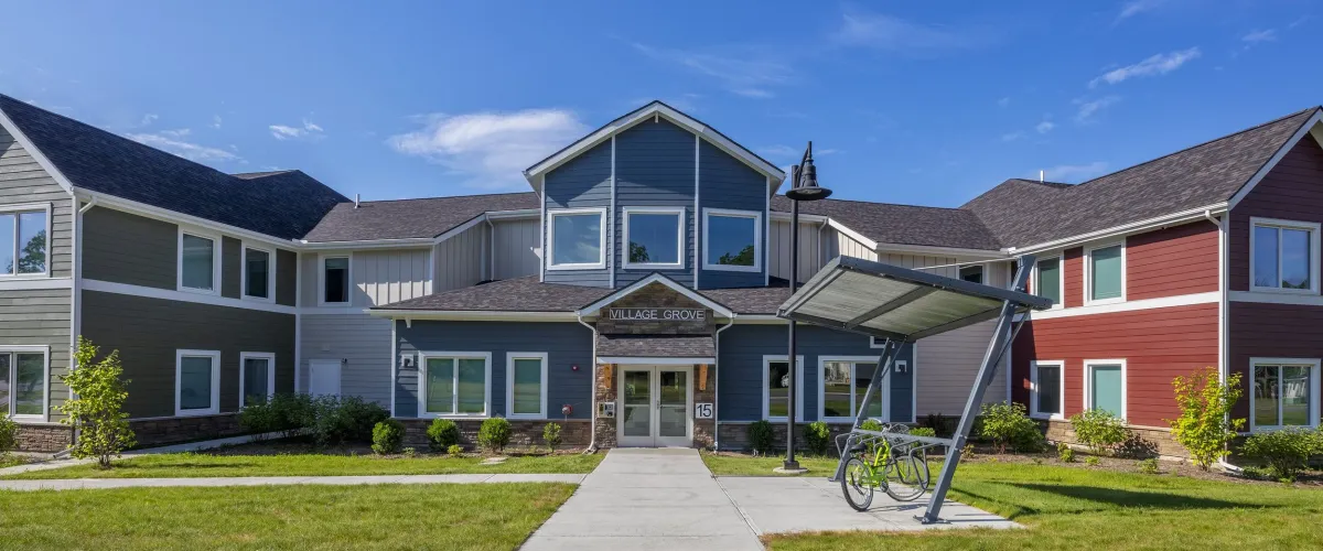 Sidewalk view of Village Grove Apartments