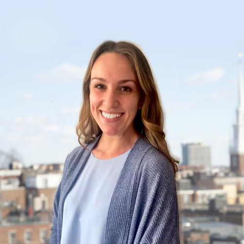 Headshot of Kate in front of Boston's north-end neighborhood.