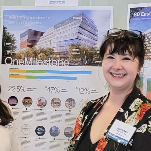 Headshot of Autumn in front of One Milestone Project Award