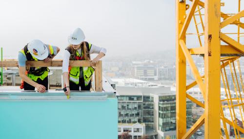 Two engineers working on a rooftop.