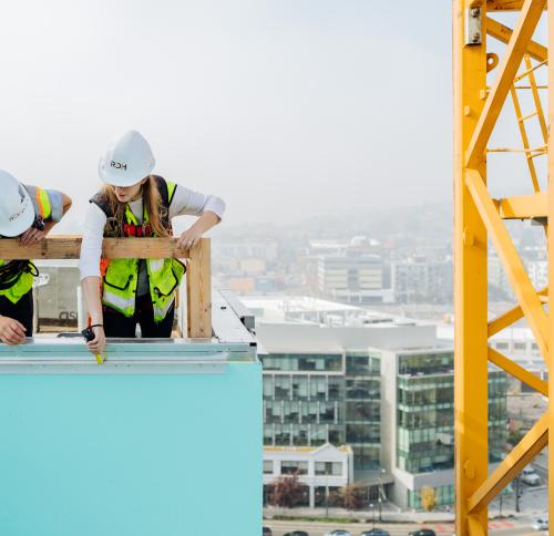 Two engineers working on a rooftop.