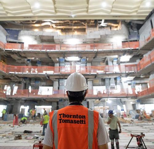 Man looking out at worksite wearing Thornton Tomasetti work vest