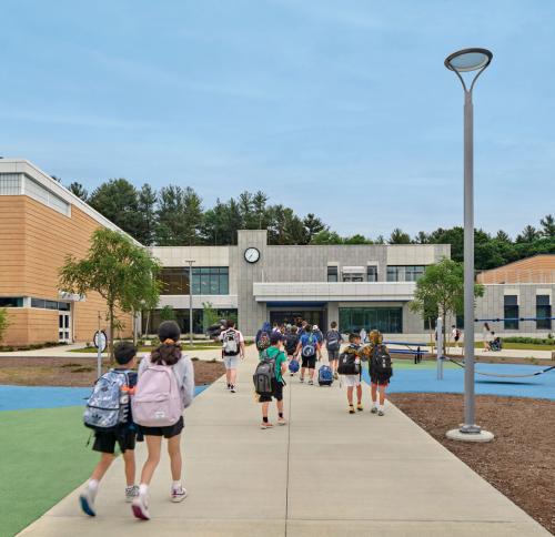 Children walk toward the entryway into the David Mindess Elementary school.