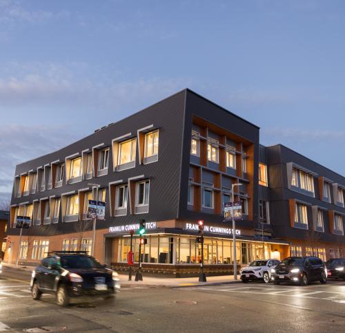 Street view of completed Franklin Cummings Tech building at night.