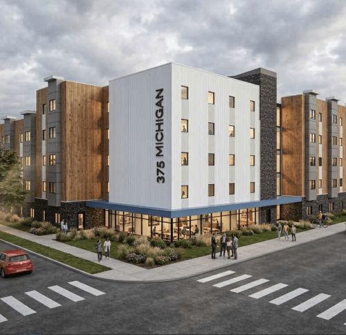 Architectural rendering of the five-story 375 Michigan Avenue affordable housing development in Buffalo, showing the main entrance, varied brick and white façades, and the building extending along the street.