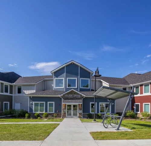 Sidewalk view of Village Grove Apartments